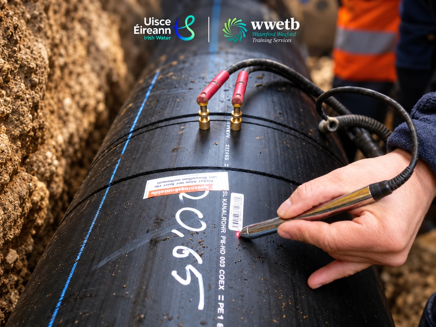 Scanning an electrofusion fitting barcode on a PE pipeline, with Uisce Éireann and WWETB branding
